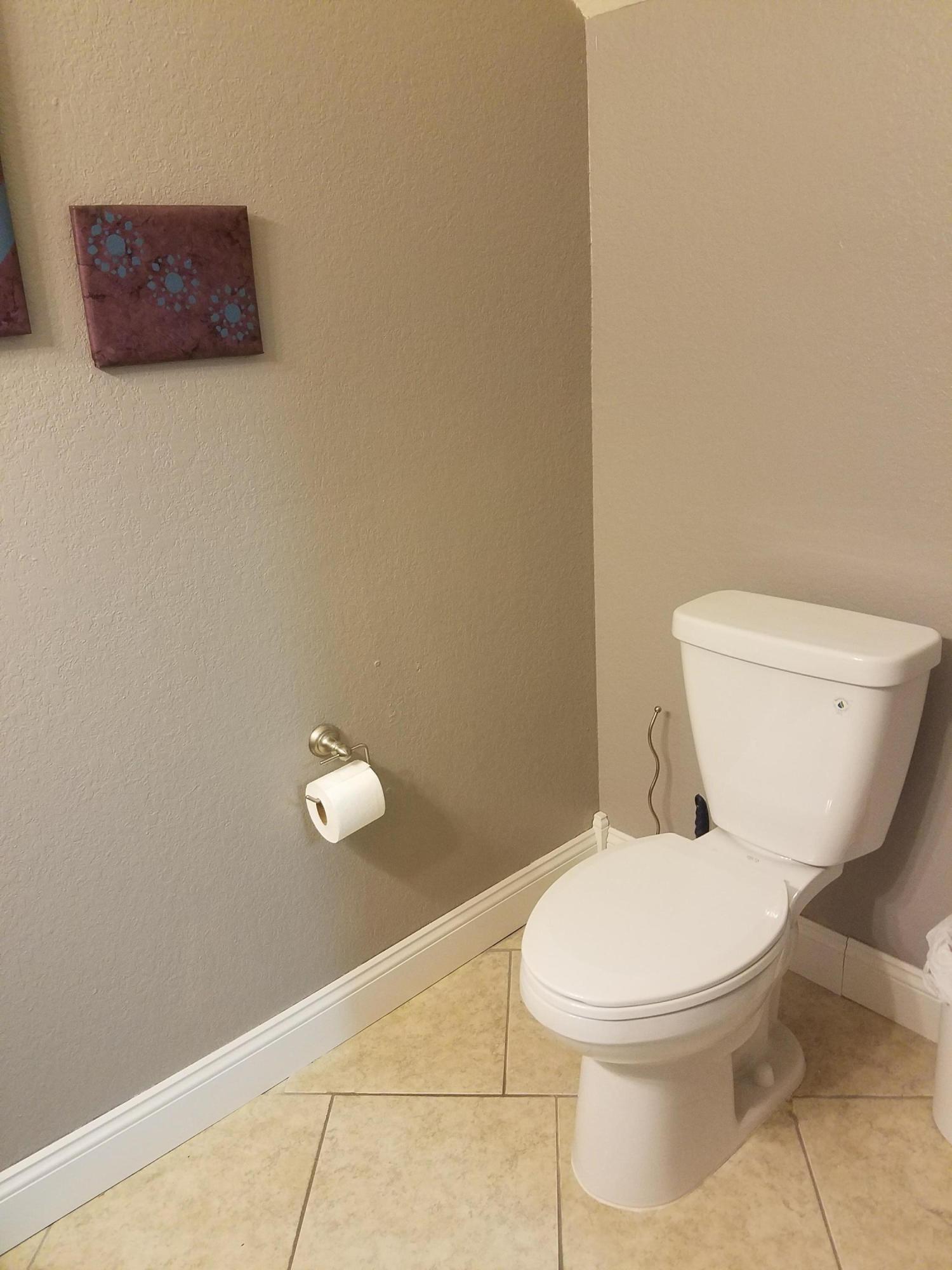 1014 Airport Road, Unit 105 Destin, FL 32541 - Photo 10 of 25 a white toilet sitting next to a white wall