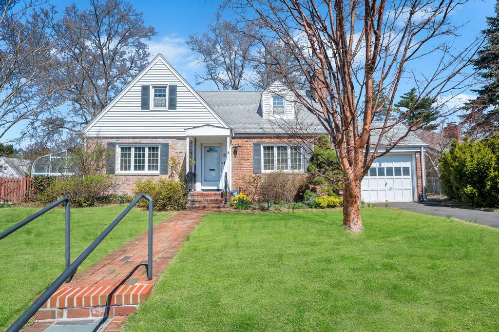 8 Brown Road Great Neck, NY 11024 - Photo 1 of 1 a front view of a house with a yard and trees