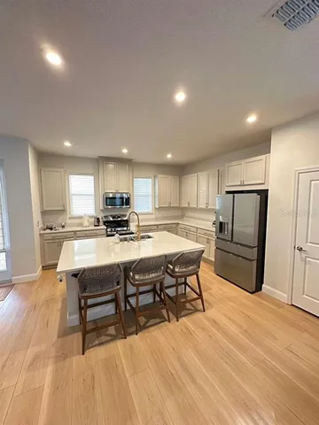 a kitchen with a sink appliances and cabinets