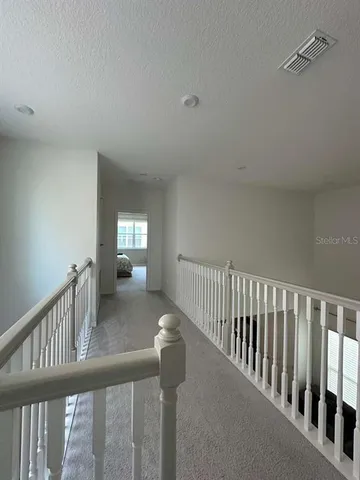 a view of a hallway view with staircase