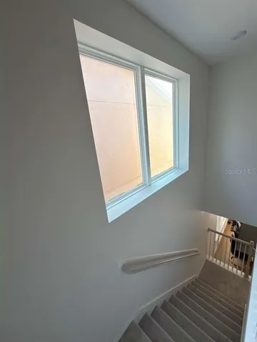 a view of a room with wooden floor and a window