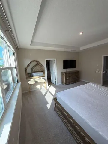 a bedroom with a bed and a tv on desk