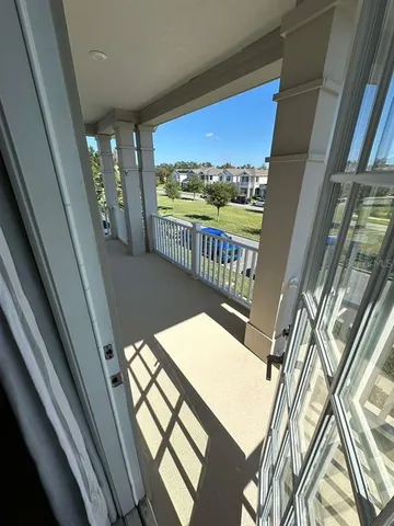 a view of balcony with wooden floor
