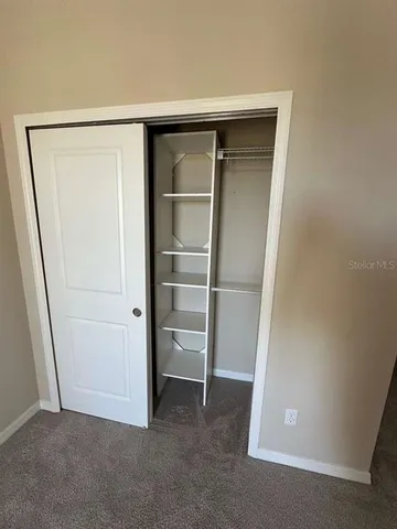 a view of a hallway to rooms and stairs