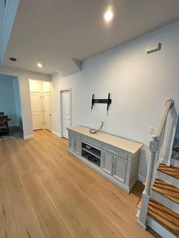 a spacious bedroom with a bed and a chandelier