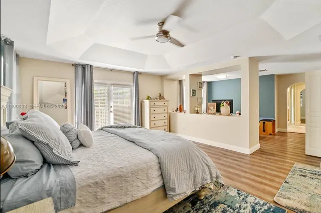 a spacious bedroom with a bed and ceiling fan