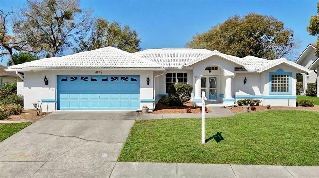 a view of house with backyard