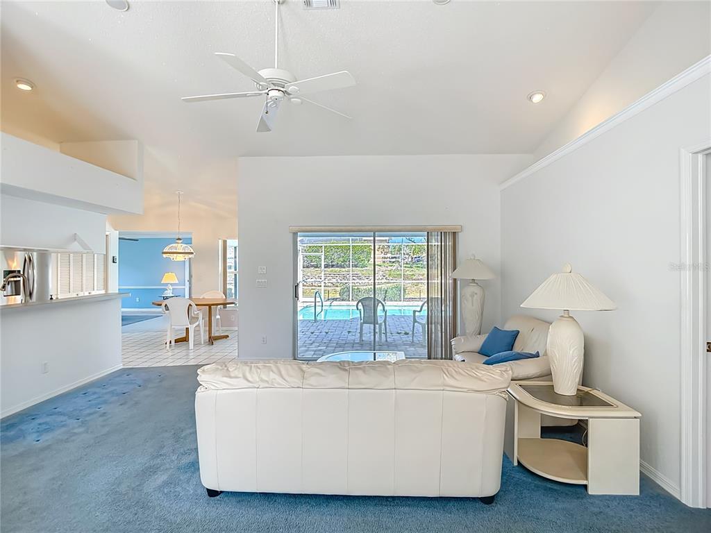 1039 Greenturf Road Spring Hill, FL 34608 - Photo 11 of 52 a living room with furniture and a table