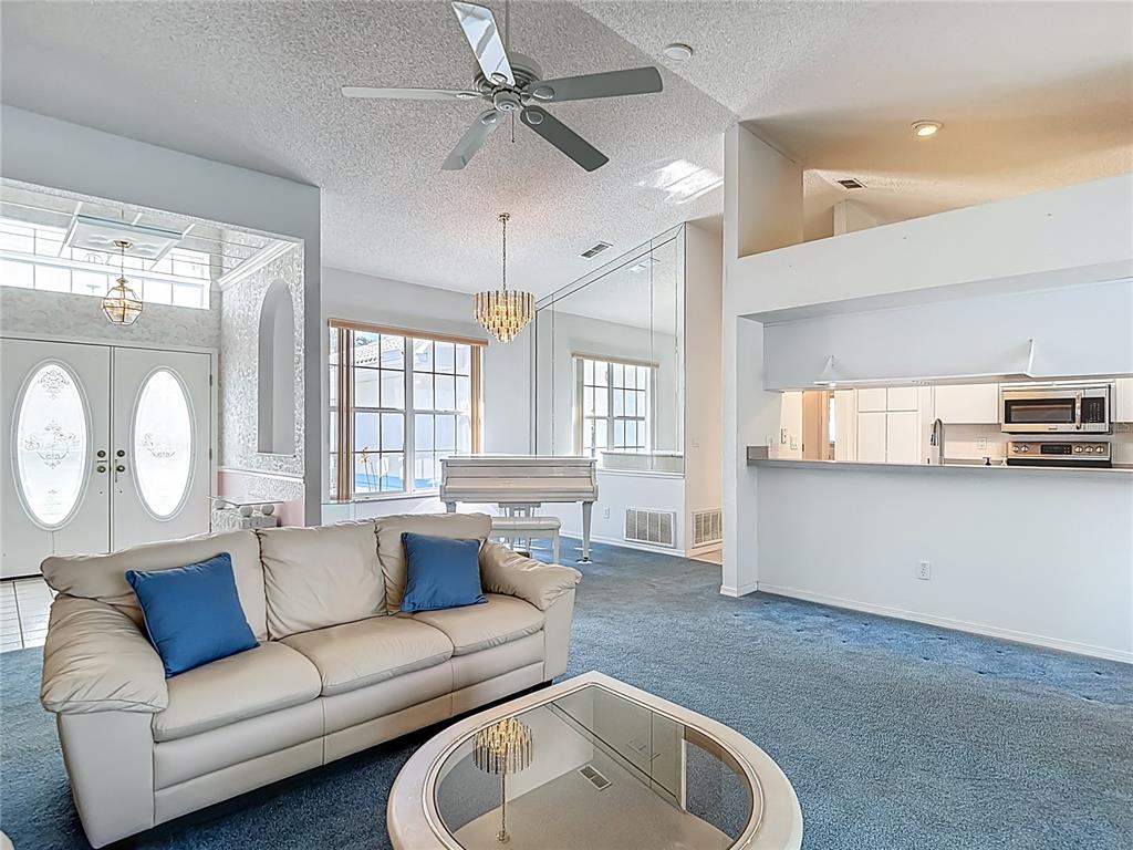 1039 Greenturf Road Spring Hill, FL 34608 - Photo 12 of 52 a living room with furniture and a large window