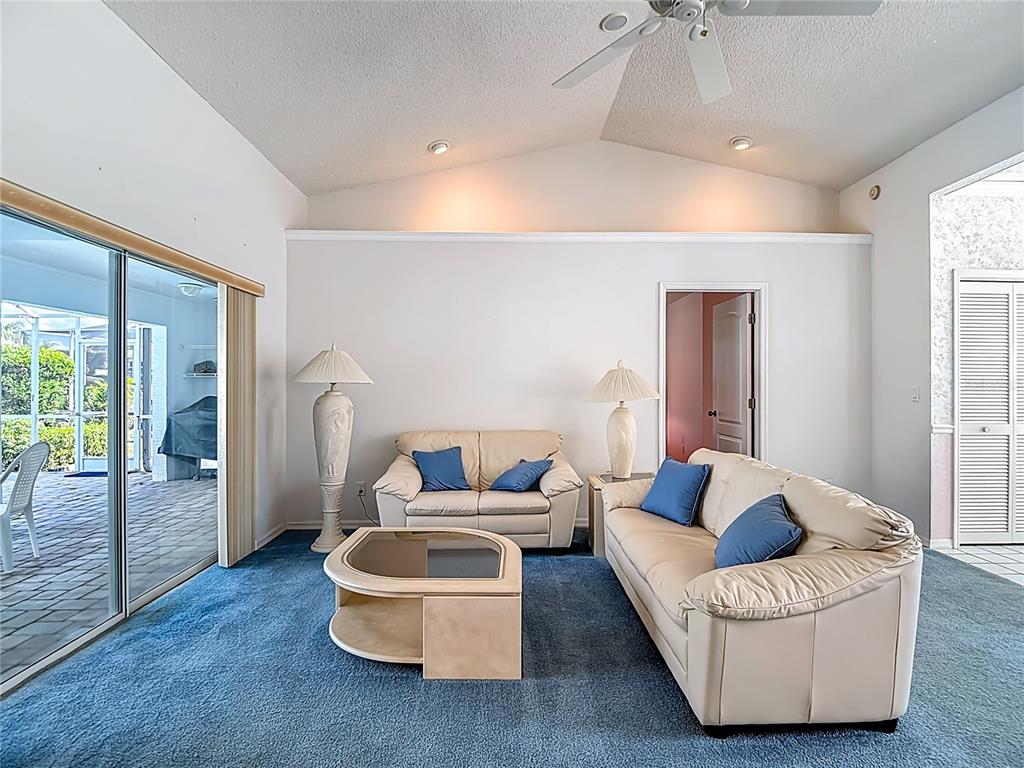 1039 Greenturf Road Spring Hill, FL 34608 - Photo 14 of 52 a living room with furniture and a large window