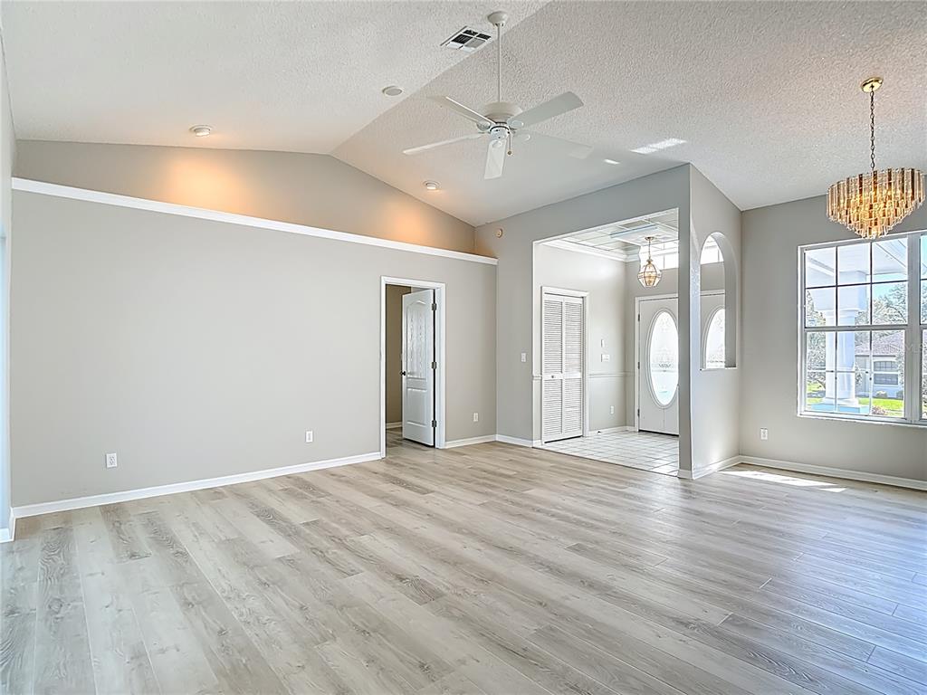 1039 Greenturf Road Spring Hill, FL 34608 - Photo 15 of 60 an empty room with wooden floor and windows