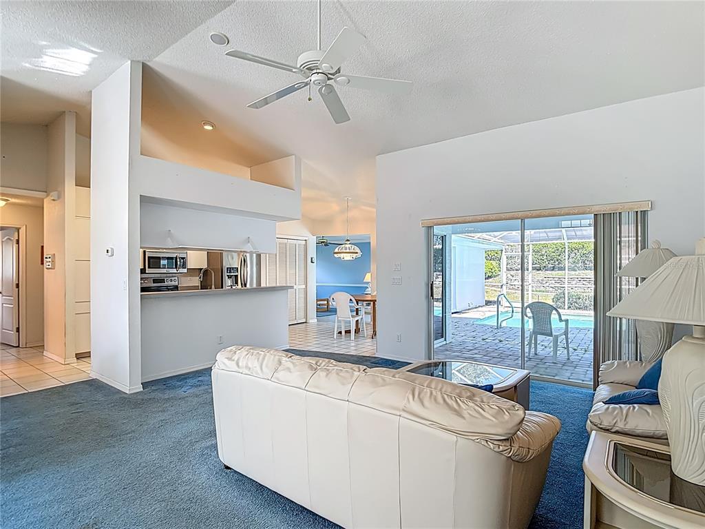 1039 Greenturf Road Spring Hill, FL 34608 - Photo 17 of 52 a living room with furniture and a table