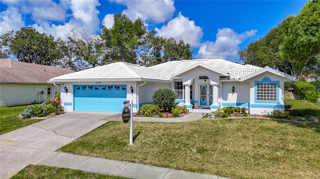 1039 Greenturf Road Spring Hill, FL 34608 - Photo 2 of 52 a front view of a house with garden