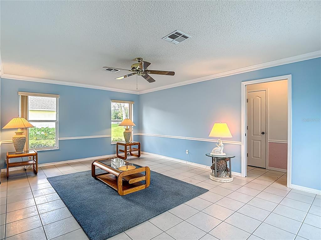 1039 Greenturf Road Spring Hill, FL 34608 - Photo 29 of 52 a living room with furniture and a table