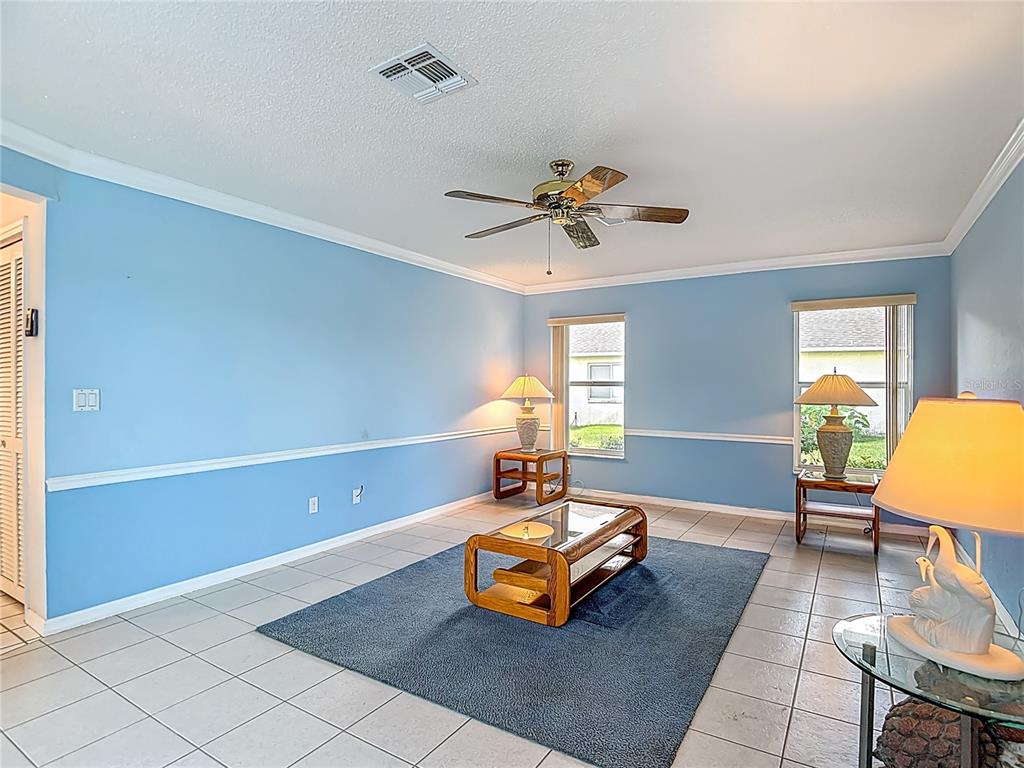 1039 Greenturf Road Spring Hill, FL 34608 - Photo 30 of 52 a living room with furniture and a table