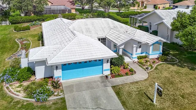 an aerial view of a house with yard