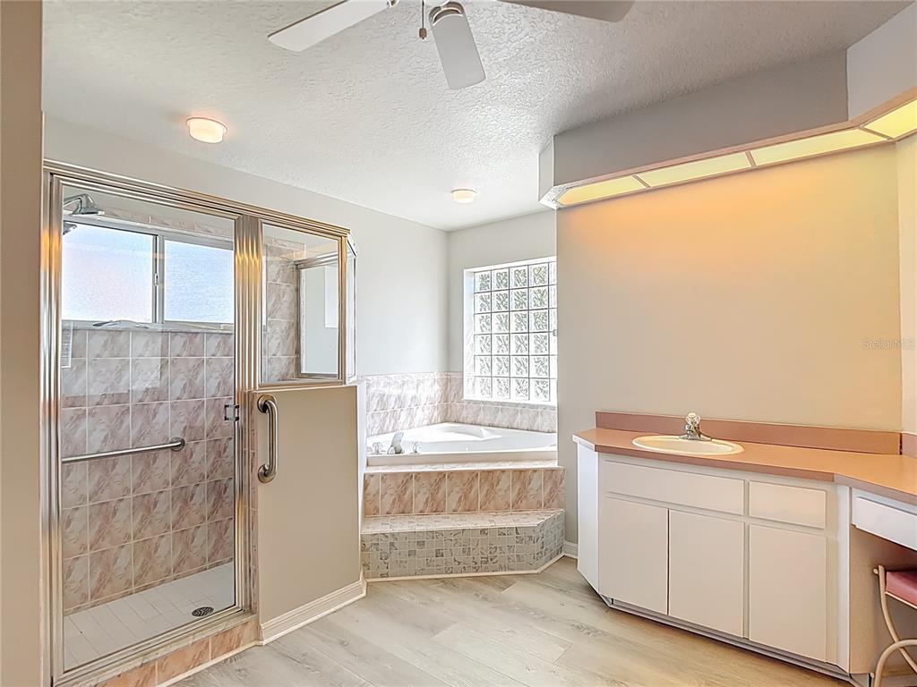 1039 Greenturf Road Spring Hill, FL 34608 - Photo 32 of 60 a bathroom with a tub shower and sink