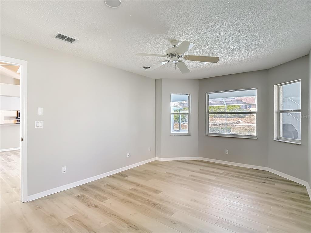 1039 Greenturf Road Spring Hill, FL 34608 - Photo 33 of 60 a view of empty room with wooden floor and fan