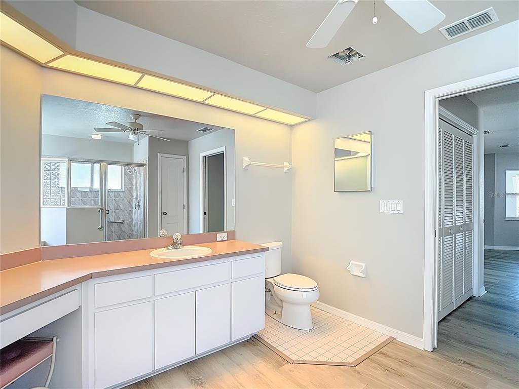 1039 Greenturf Road Spring Hill, FL 34608 - Photo 36 of 60 a spacious bathroom with a double vanity sink a mirror and a shower