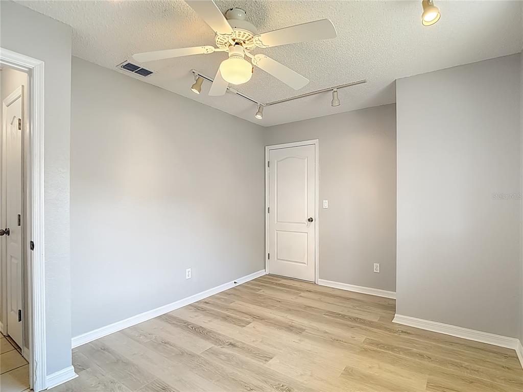 1039 Greenturf Road Spring Hill, FL 34608 - Photo 41 of 60 a view of a chandelier fan and closet in a room