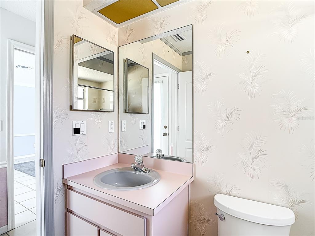 1039 Greenturf Road Spring Hill, FL 34608 - Photo 41 of 52 a bathroom with a sink toilet vanity and shower