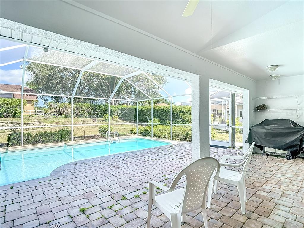 1039 Greenturf Road Spring Hill, FL 34608 - Photo 46 of 52 a living room with a large window and a yard