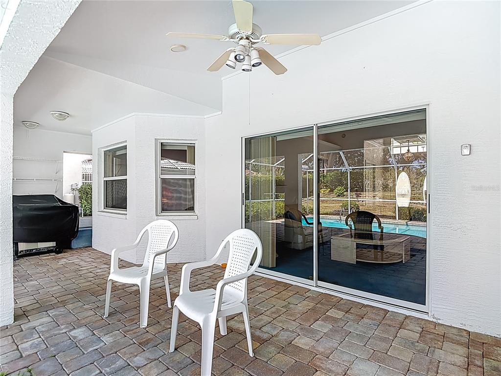 1039 Greenturf Road Spring Hill, FL 34608 - Photo 48 of 52 a dining room with furniture and large windows