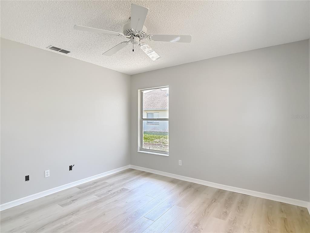 1039 Greenturf Road Spring Hill, FL 34608 - Photo 48 of 60 wooden floor in an empty room with a window