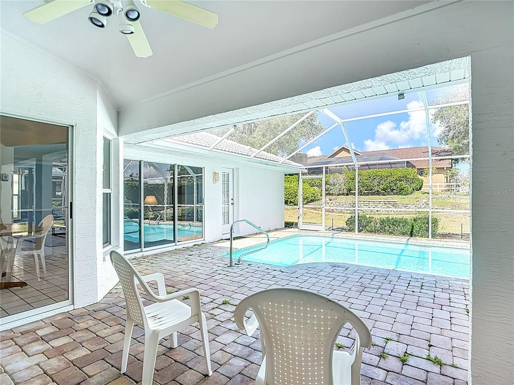 1039 Greenturf Road Spring Hill, FL 34608 - Photo 49 of 52 a swimming pool with outdoor seating and yard