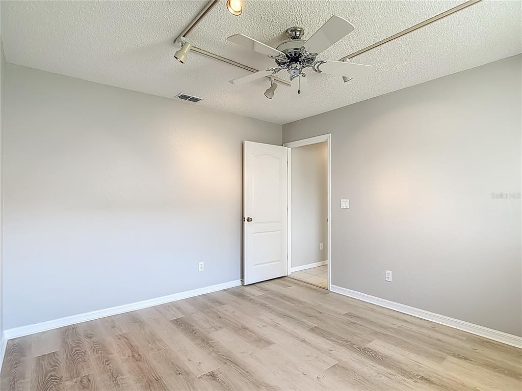 1039 Greenturf Road Spring Hill, FL 34608 - Photo 49 of 60 an empty room with a ceiling fan and a window