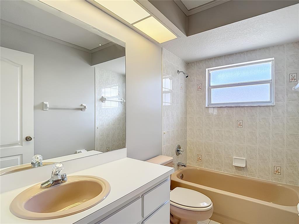 1039 Greenturf Road Spring Hill, FL 34608 - Photo 50 of 60 a bathroom with a sink a toilet and a bathtub