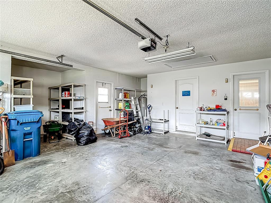 1039 Greenturf Road Spring Hill, FL 34608 - Photo 51 of 52 a garage with furniture a air conditioner and a window