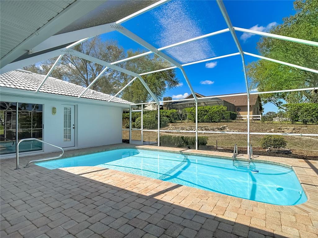 1039 Greenturf Road Spring Hill, FL 34608 - Photo 55 of 60 a view of a backyard with swimming pool and sitting area
