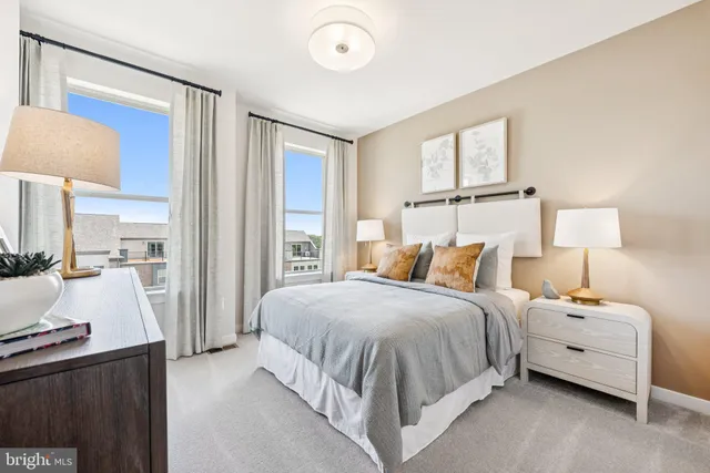 a bedroom with a bed and a lamp with the dresser