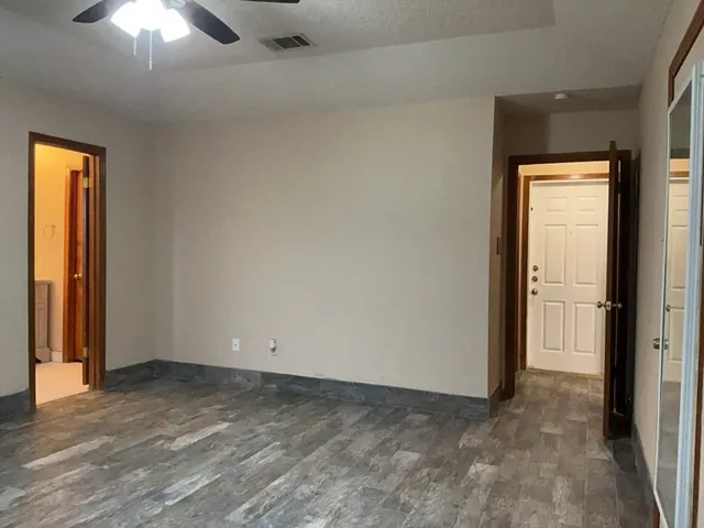an empty room that has a window in it