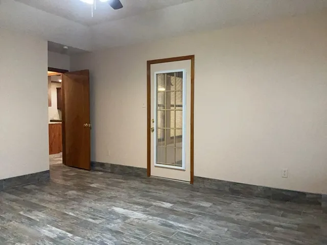 an empty room with wooden floor and closet