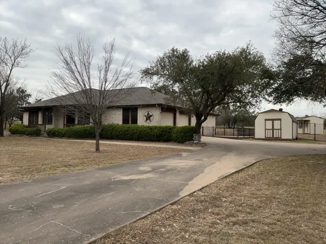 a front view of a house with a trees