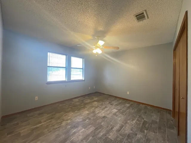 an empty room with a empty space and a ceiling fan