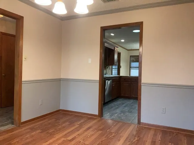 a view of hallway with wooden floor