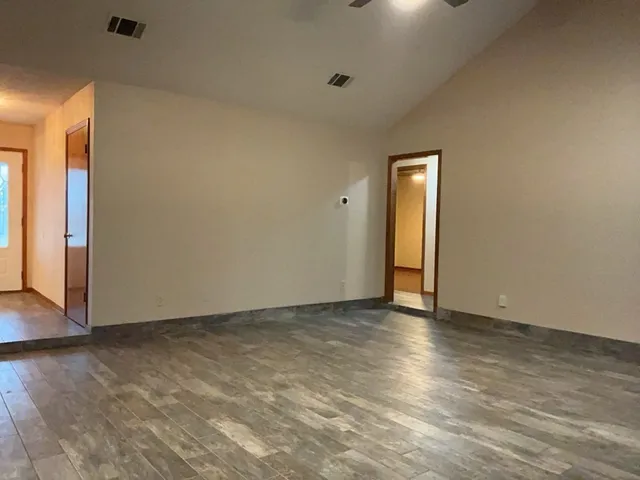 a view of an empty room and wooden floor