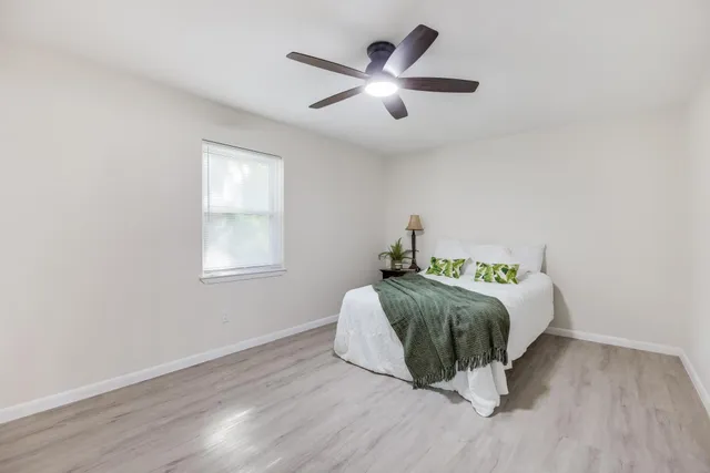 a bedroom with a bed and wooden floor