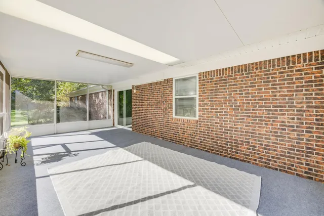 a view of a livingroom with furniture and a ceiling fan