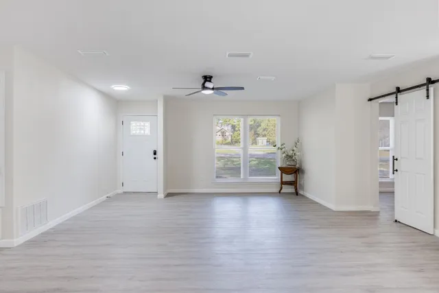 a view of livingroom with hardwood floor and a ceiling fan