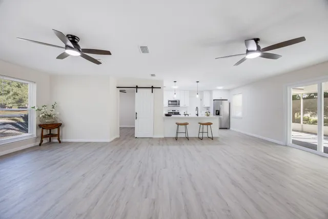 a kitchen with white cabinets and a stove with a sink