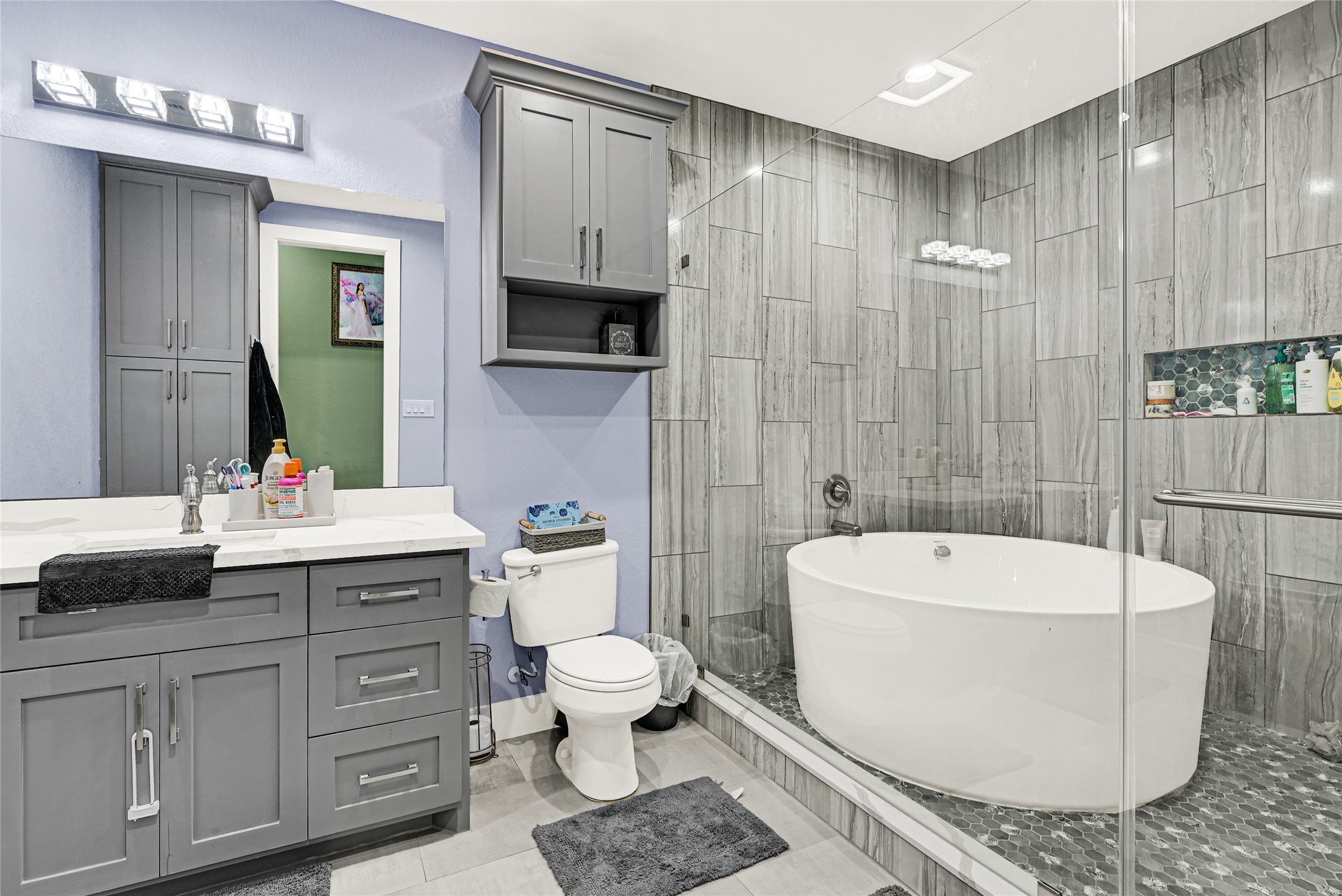 4821 1st Street Houston, TX 77504 - Photo 33 of 48 a bathroom with a double vanity sink a toilet a mirror and bathtub