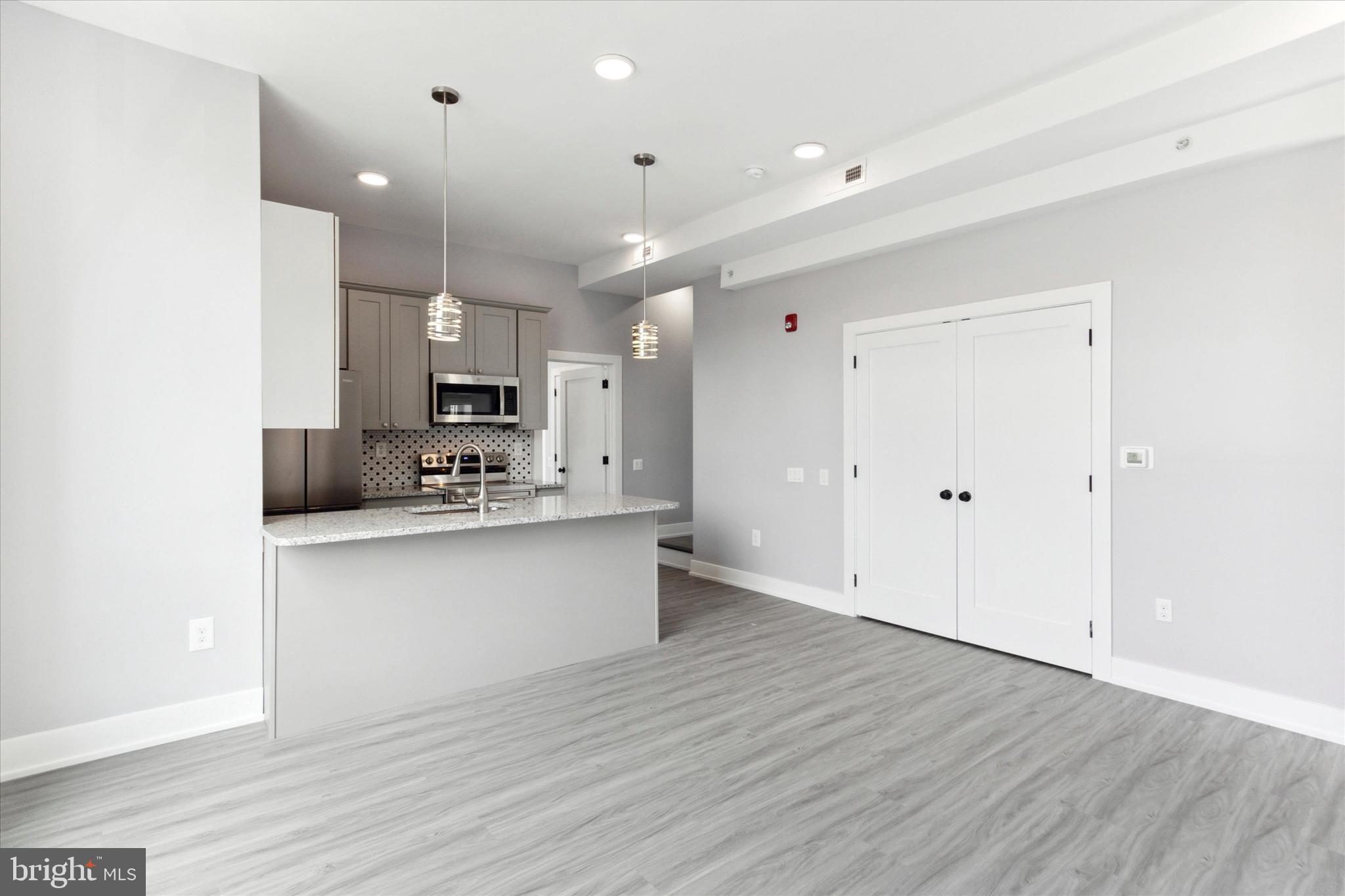 650 South Street, Unit 3 Philadelphia, PA 19147 - Photo 2 of 13 a kitchen with stainless steel appliances granite countertop a sink cabinets and wooden floor