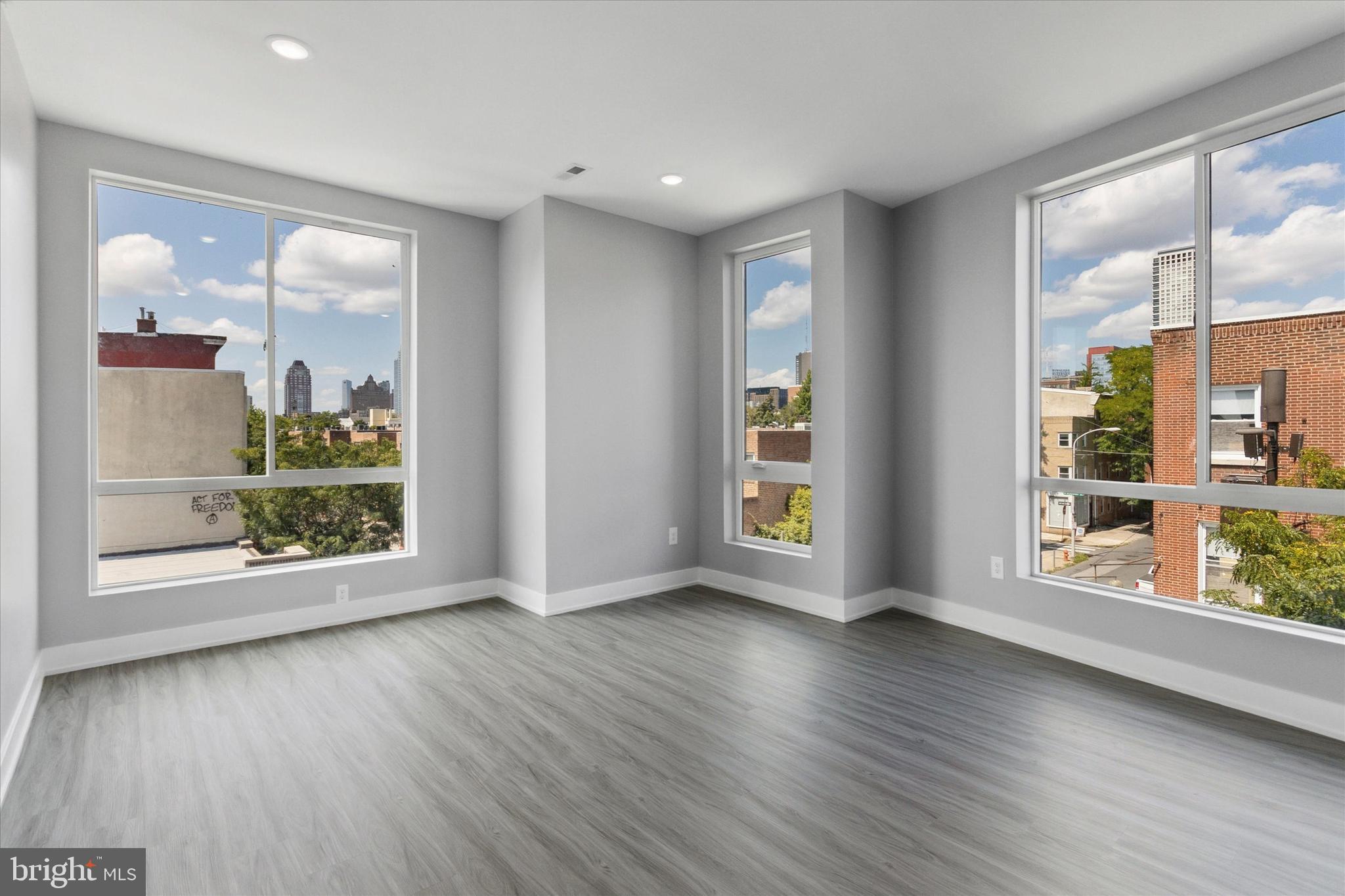 650 South Street, Unit 3 Philadelphia, PA 19147 - Photo 6 of 13 an empty room with wooden floor and windows