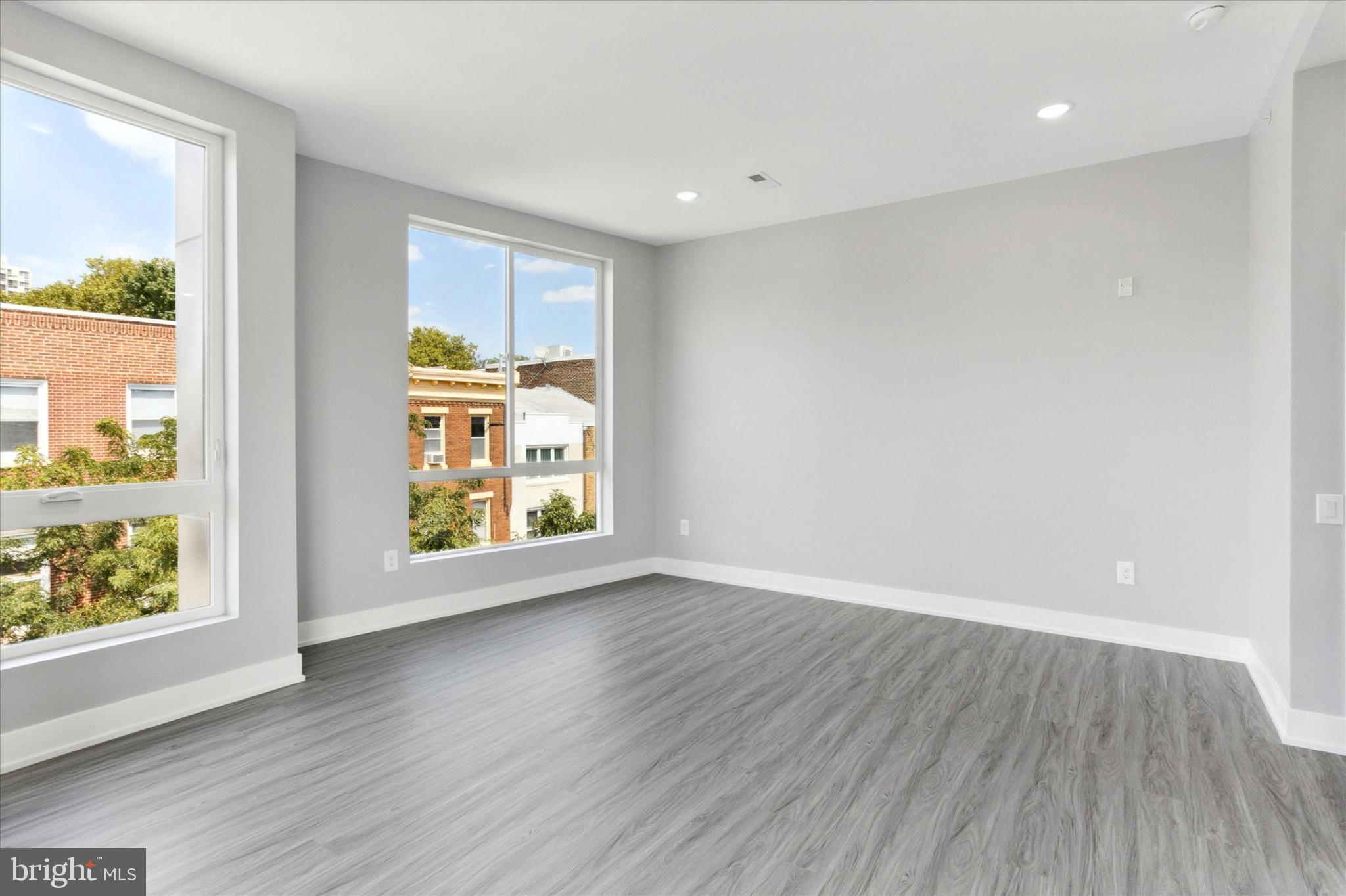 650 South Street, Unit 3 Philadelphia, PA 19147 - Photo 7 of 13 an empty room with wooden floor and windows