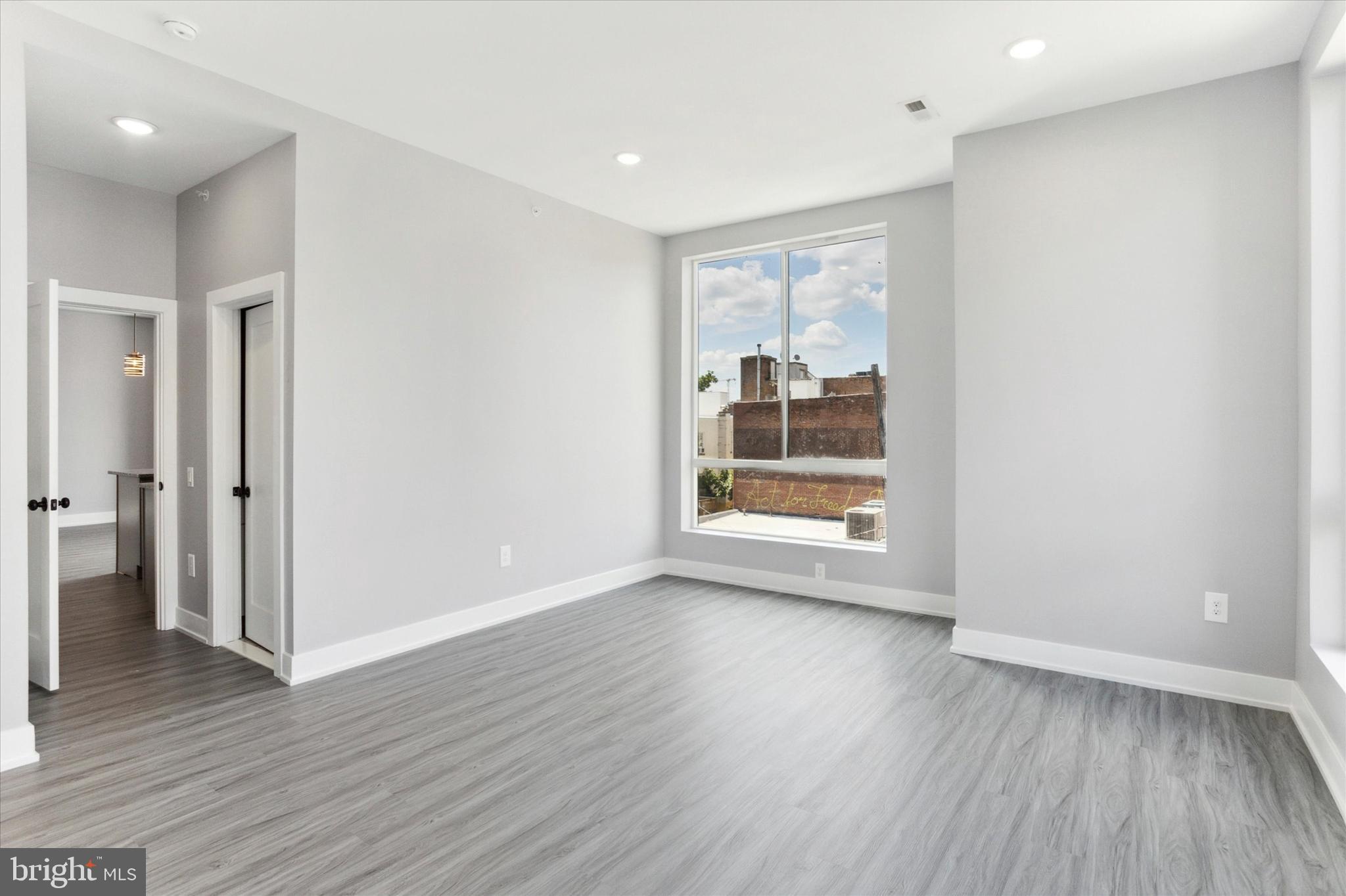 650 South Street, Unit 3 Philadelphia, PA 19147 - Photo 8 of 13 wooden floor in an empty room with a window