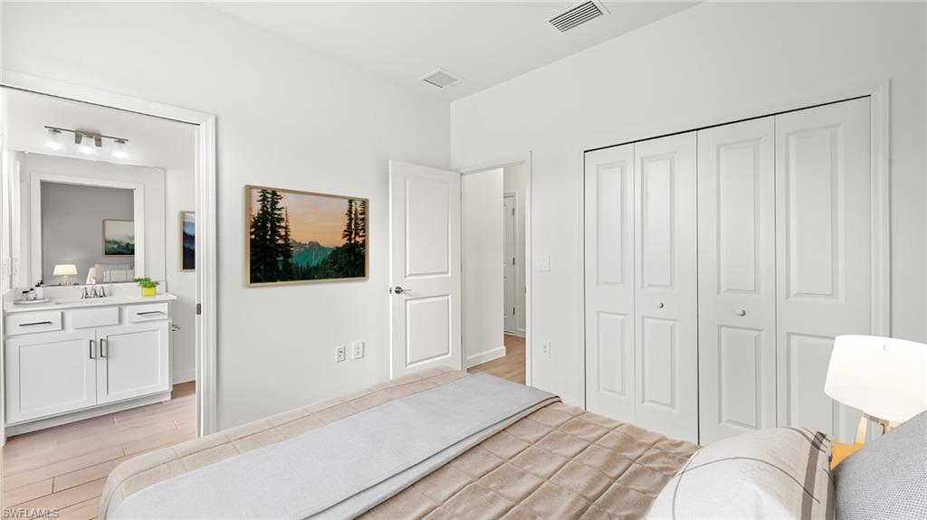 21090 Verawood Loop Estero, FL 33928 - Photo 13 of 17 a spacious bedroom with a bed and a bathroom